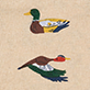View Decoy Ducks Tea Towel - Two colorful duck illustrations on a beige background