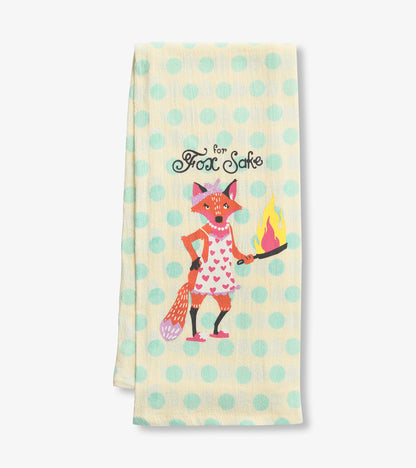 Yellow tea towel with teal polka dots featuring a cartoon fox holding a flaming pan, text reads "For Fox Sake.