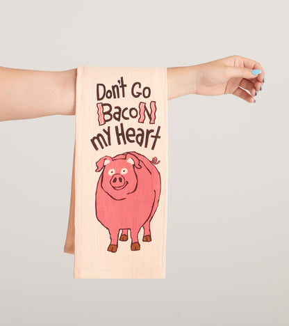 Pink tea towel featuring a cartoon pig and the text "Don't Go Bacon My Heart" in bold lettering.