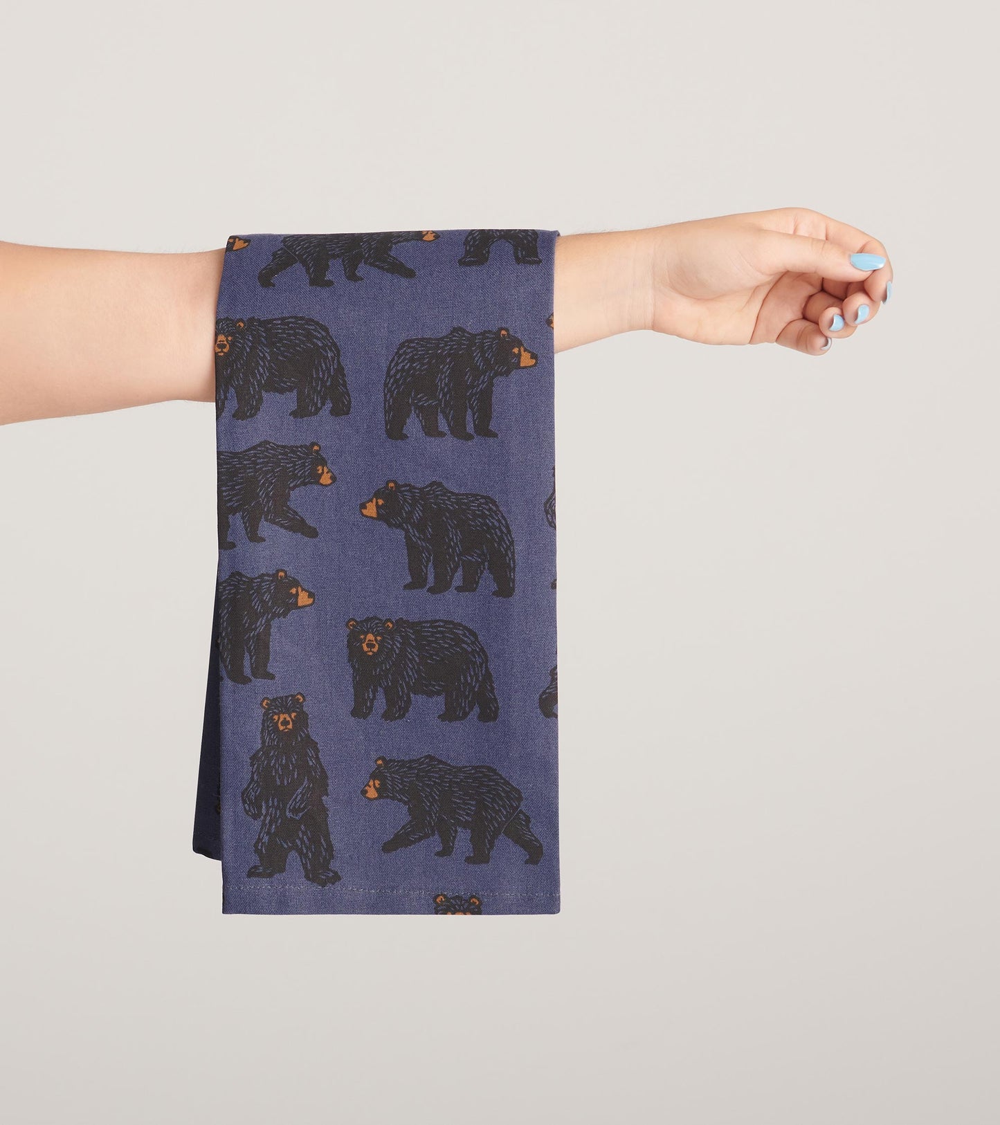 Navy tea towel featuring a playful bear pattern, ideal for kitchen use.