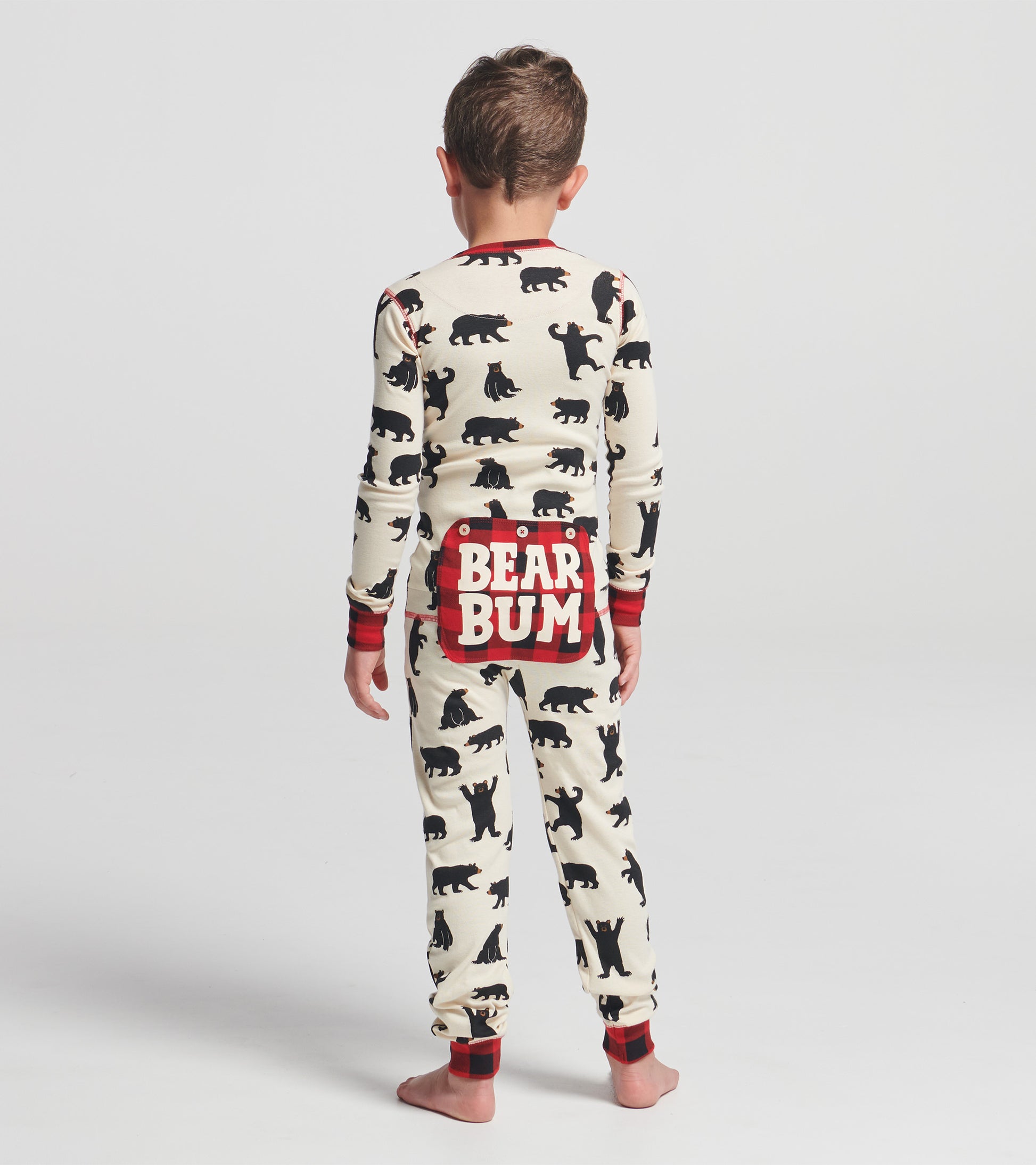 Kids' black bear patterned onesie with red accents and "BEAR BUM" graphic on the back, shown from the back.