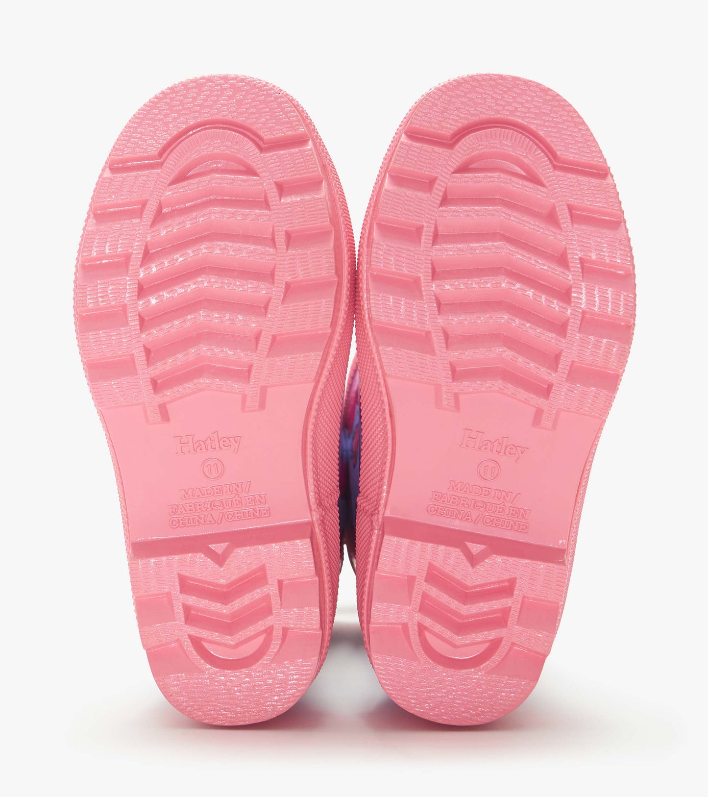 Pink rubber rain boot soles with tread pattern, shown from the bottom view