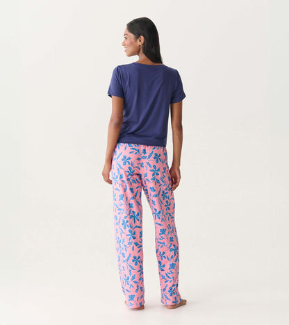 Back view of pink pajama pants with blue floral print, paired with a navy short-sleeve top.