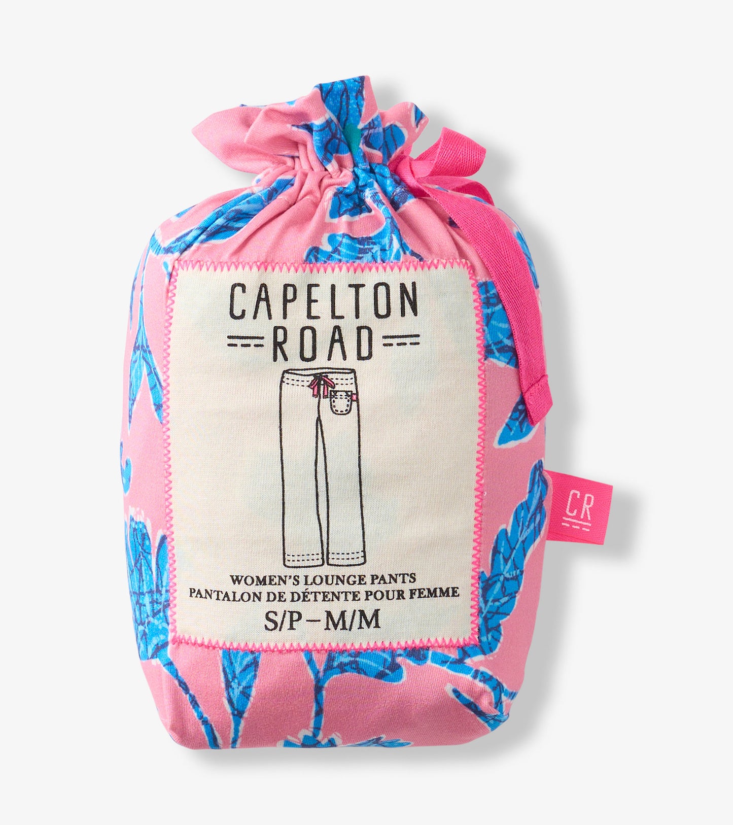 Folded pink pajama pants with blue floral batik print, packaged in a drawstring pouch with label.