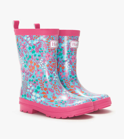 Girls’ blue floral rain boots with pink trim and soles, shown in side view