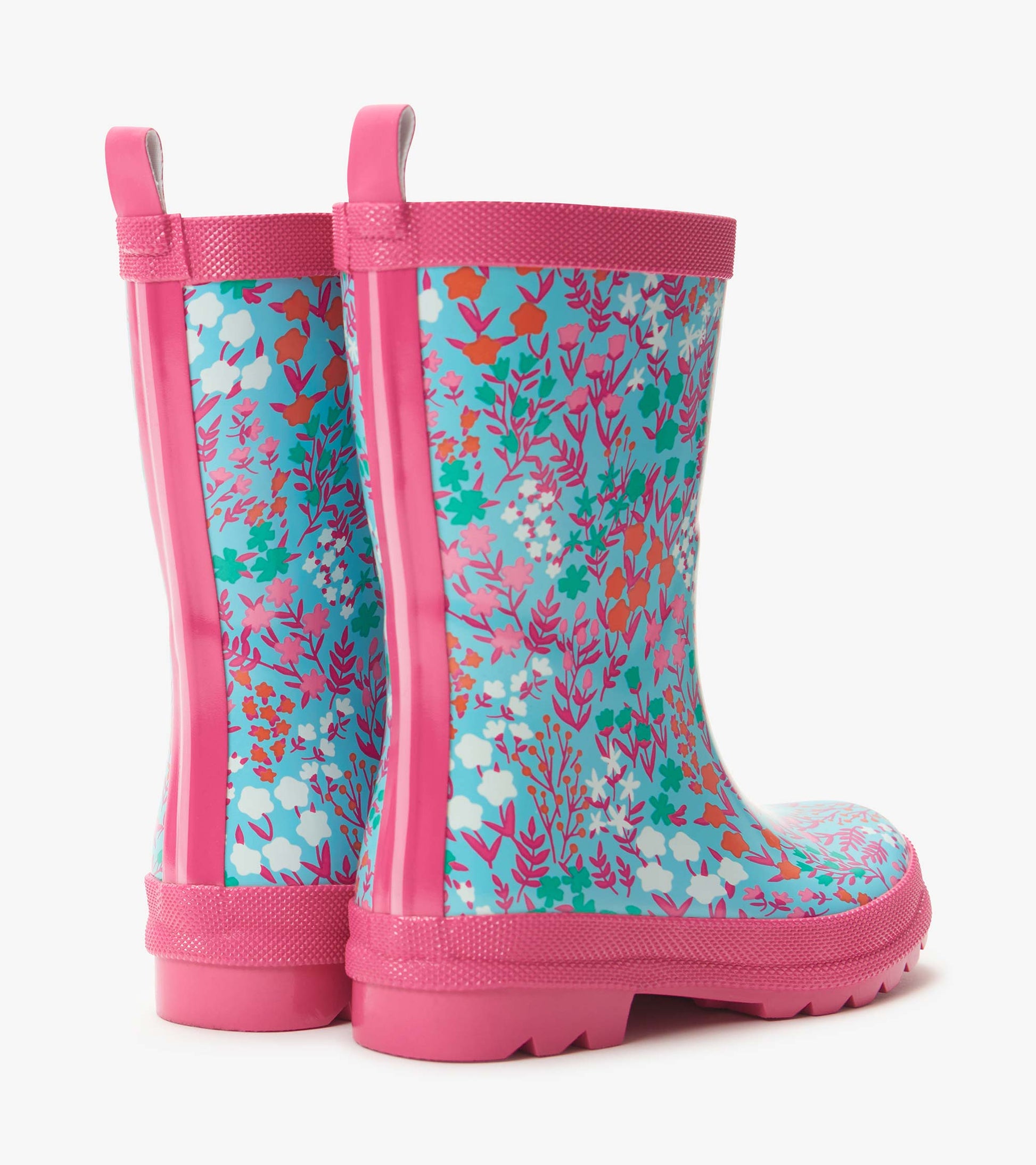 Pink and turquoise kids rain boots with colorful wildflower print, side view
