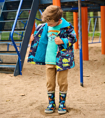 Boy wearing navy dinosaur-print rain jacket with turquoise lining and hood, open front view