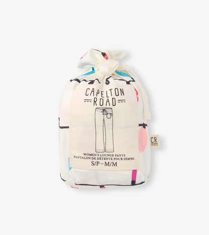 Drawstring bag containing women's pajama pants with a colorful, playful pattern. Size options visible on the label.
