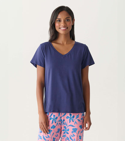 Woman wearing a navy short-sleeve V-neck T-shirt with a relaxed fit, shown front view.