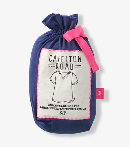 Navy fabric drawstring pouch with pink ribbon and label showing a V-neck T-shirt illustration.