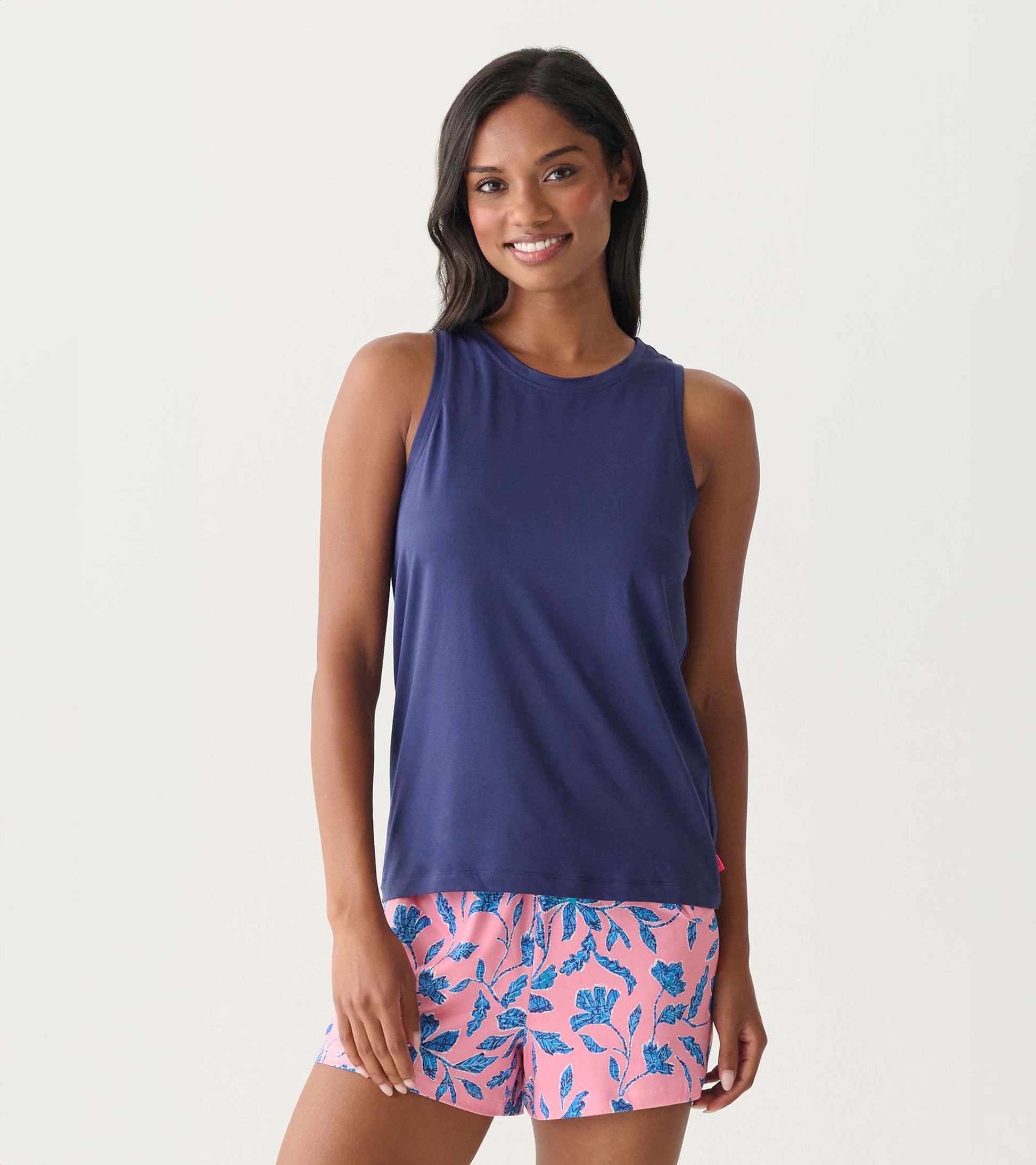 Navy sleeveless scoop neck tank top with a relaxed fit, shown on a model.