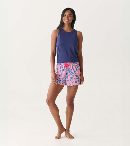 Front view of a navy scoop neck tank top on a model, sleeveless and fitted with a smooth knit finish.