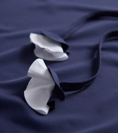 Patriot blue beach dress featuring white ruffled straps, made from soft fabric, ideal for seaside wear.