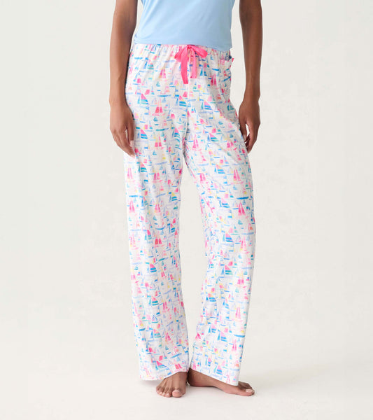 Women's white pajama pants with colorful sailboat print and pink drawstring waistband, front view