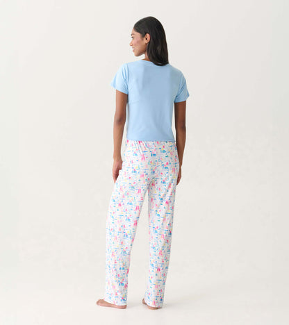 Back view of white pajama pants with colorful sailboat print, paired with a light blue top