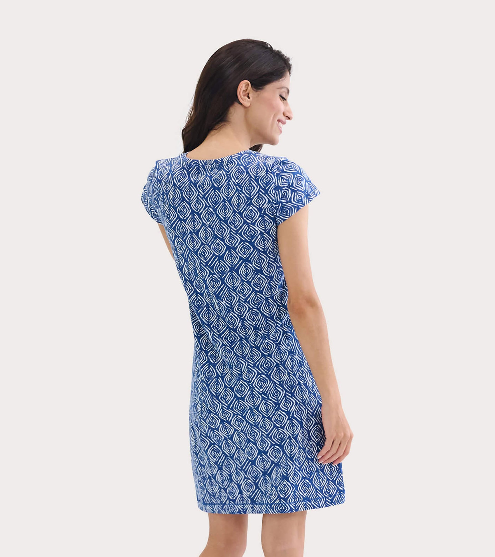 Blue patterned crew neck t-shirt dress with short sleeves, fitted shape, and above-the-knee length, shown from the back.