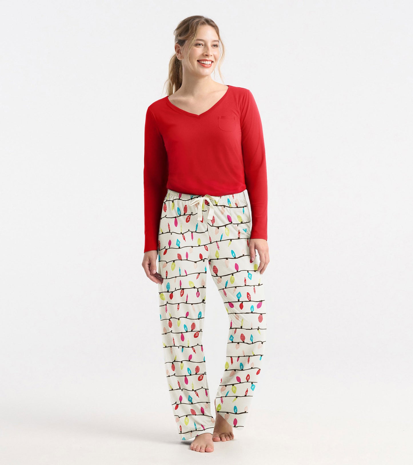 Red long sleeve polyknit t-shirt with a v-neck and a small pocket, paired with patterned pajama pants.