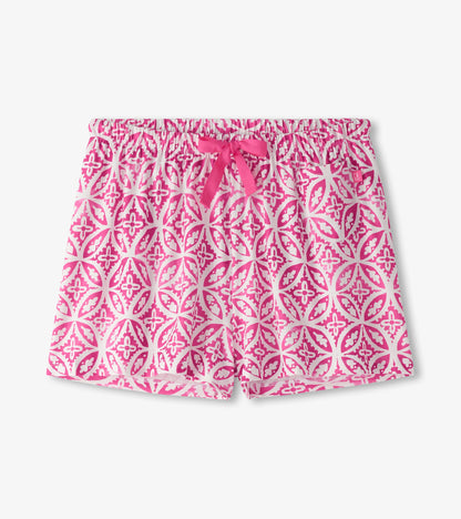 Pink pajama shorts featuring a floral pattern and an elastic waistband with a bow tie detail.