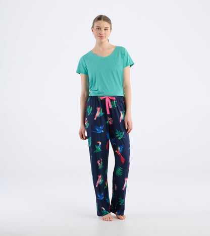 Navy pajama pants with a tropical bird print and pink drawstring, paired with a teal V-neck top.