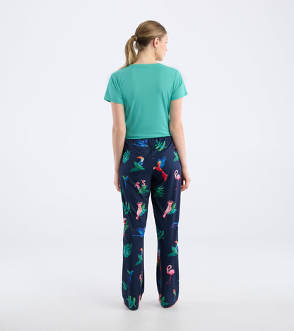 Navy pajama pants featuring a colorful tropical bird and leaf pattern, made from soft polyknit material.