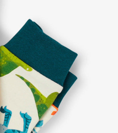 Organic cotton kids pajama set featuring colorful dinosaur patterns and teal cuffs.