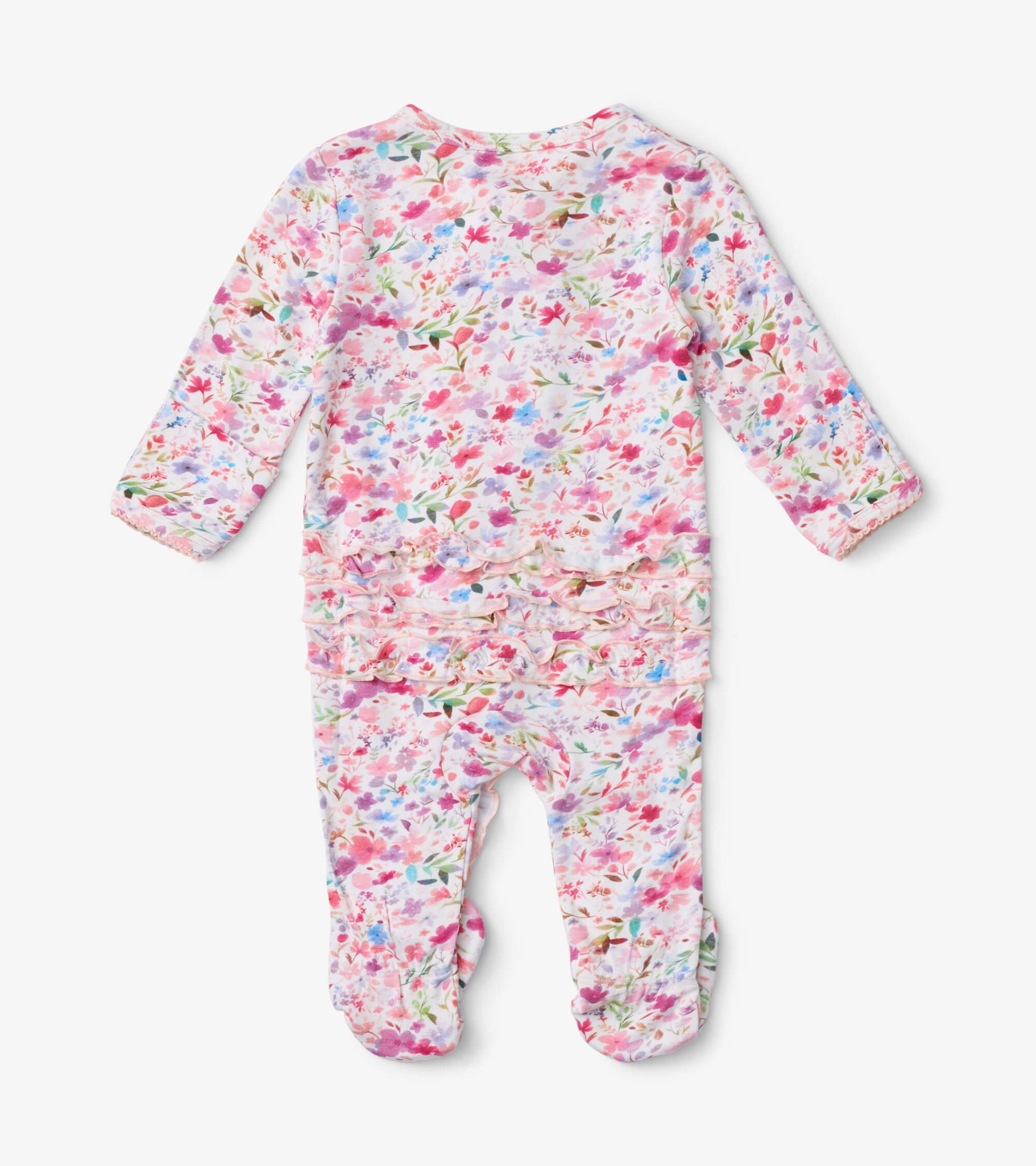 Baby footed sleeper featuring a colorful watercolor floral pattern with ruffle detailing at the back.