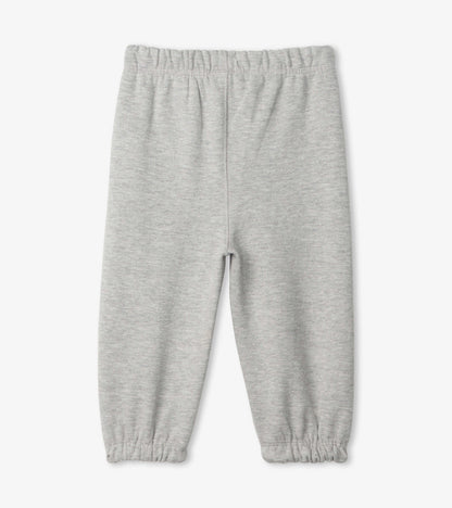 Light grey French terry baby joggers with an elastic waistband and gathered cuffs. Suitable for casual wear.