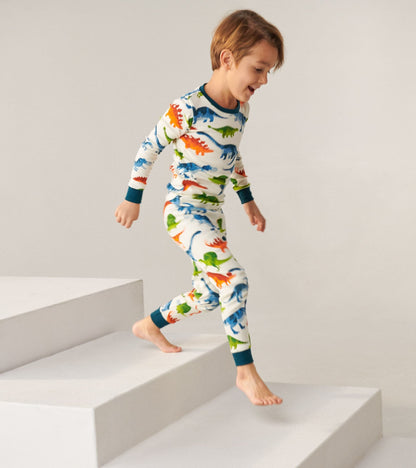 Organic cotton kids pajama set featuring colorful dinosaur patterns, long sleeves, and matching pants, ideal for sleepwear.