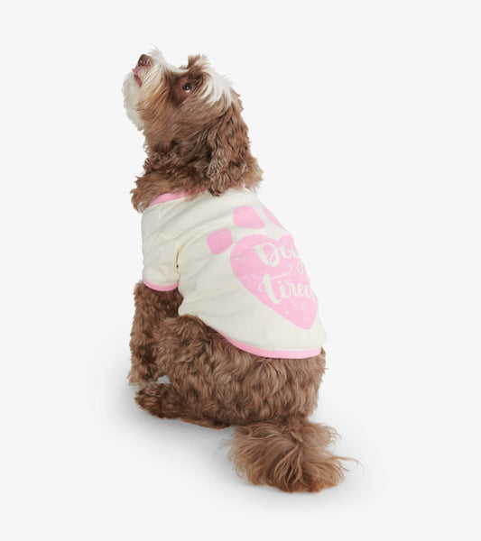 Cream dog tee with pink accents and paw print design, featuring the text "Dog Tired," worn by a seated dog.