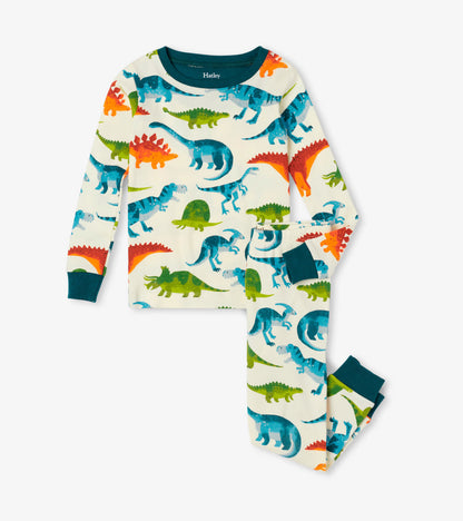 Organic cotton kids pajama set featuring colorful dinosaur patterns on a cream background with teal cuffs.