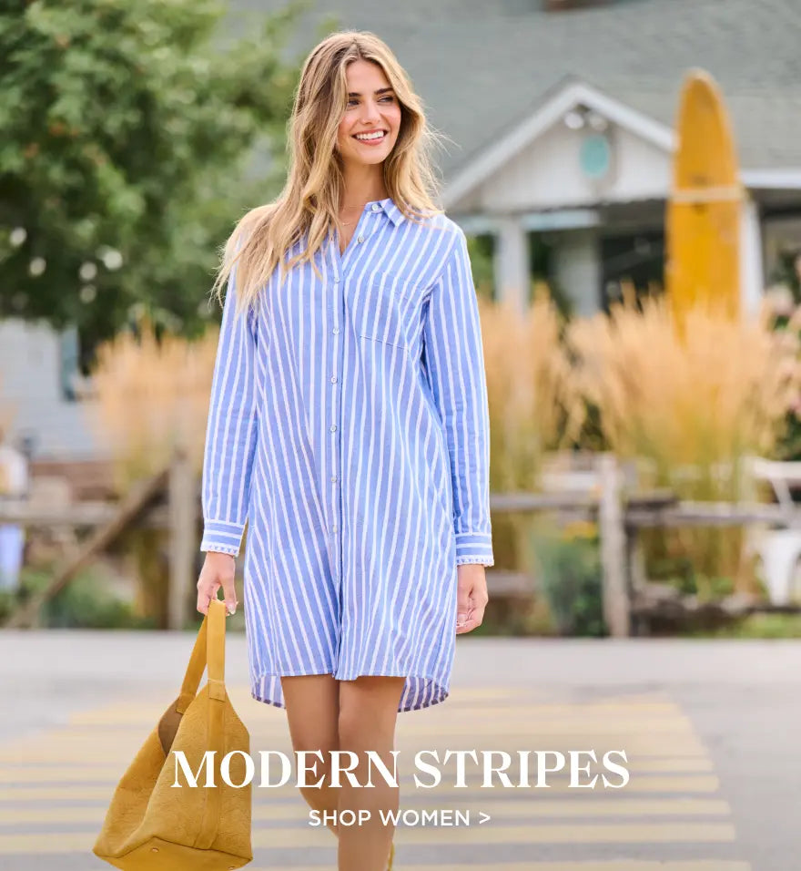 Promotes shopping women's clothing. Showing woman wearing a blue striped shirt dress and carrying a tan tote outdoors.